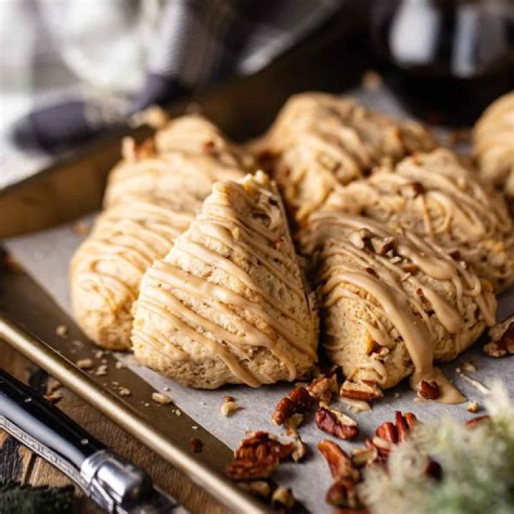 Maple scones covered in glaze on a wire rack.