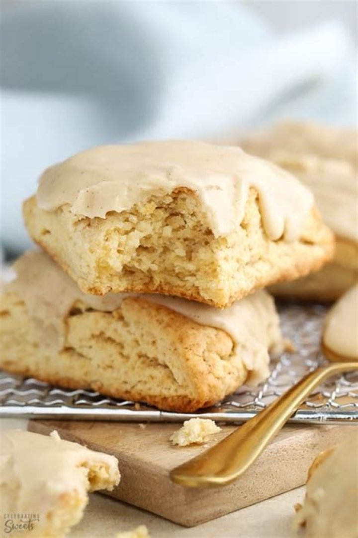 Two maple scones on a wire rack.